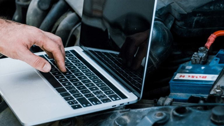 This image shows a laptop being used to connect the car for diagnosis